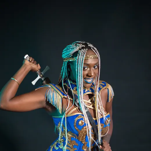 The Amazing Martika in a blue pirate costume, about to swallow a sword